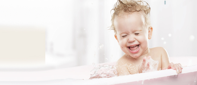 Closeup of baby splashing water in the bath